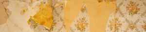 An image showing a wall where the wallpaper is peeling due to damp issues