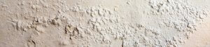 An image showing a white wall with bubbling paint due to a damp problem